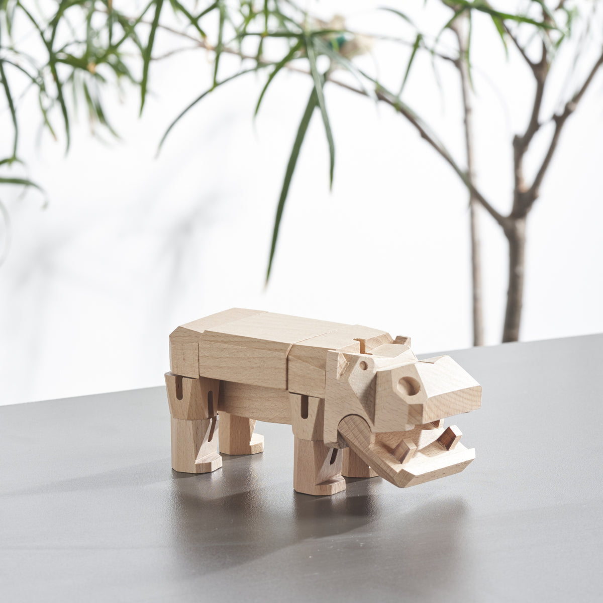 Morphits Hippo poseable wooden design object in a sculptural arrangement.