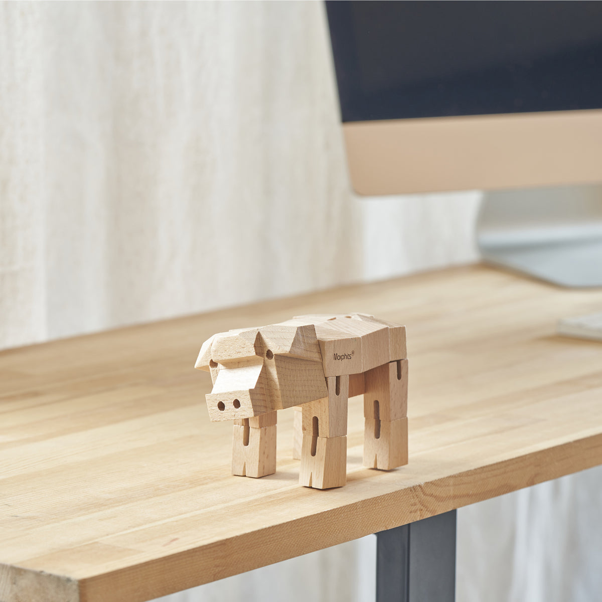 Morphits Pig poseable wooden design object in a sculptural arrangement.